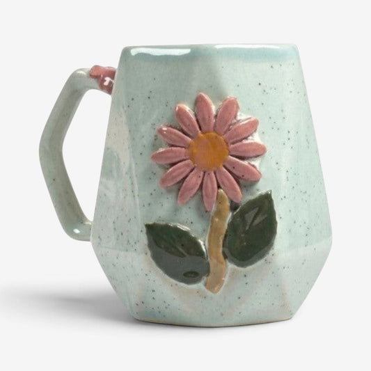 Ayethic Angular Blossom ceramic mug with a faceted light blue speckled finish and a sculpted pink flower motif.