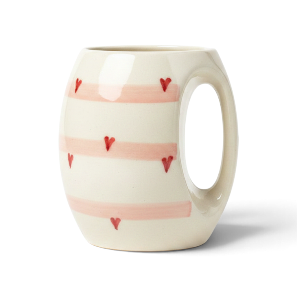 Ayethic handcrafted ceramic mug with blush pink stripes and small red heart accents on a cream background