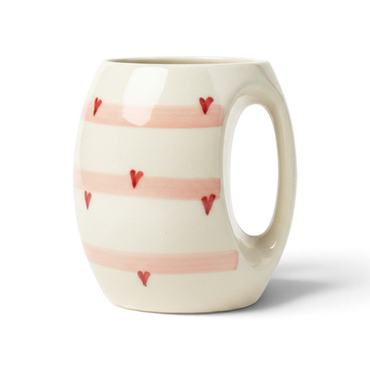 Ayethic handcrafted ceramic mug with blush pink stripes and small red heart accents on a cream background