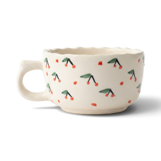 Ayethic handcrafted ceramic cup in ivory with hand-painted red cherry motifs and a scalloped rim.