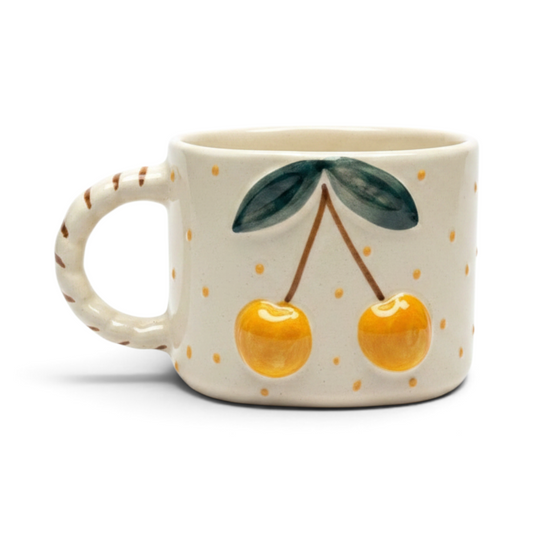 Ayethic handcrafted ceramic mug with hand-painted yellow cherries and polka dots on a cream satin glaze background