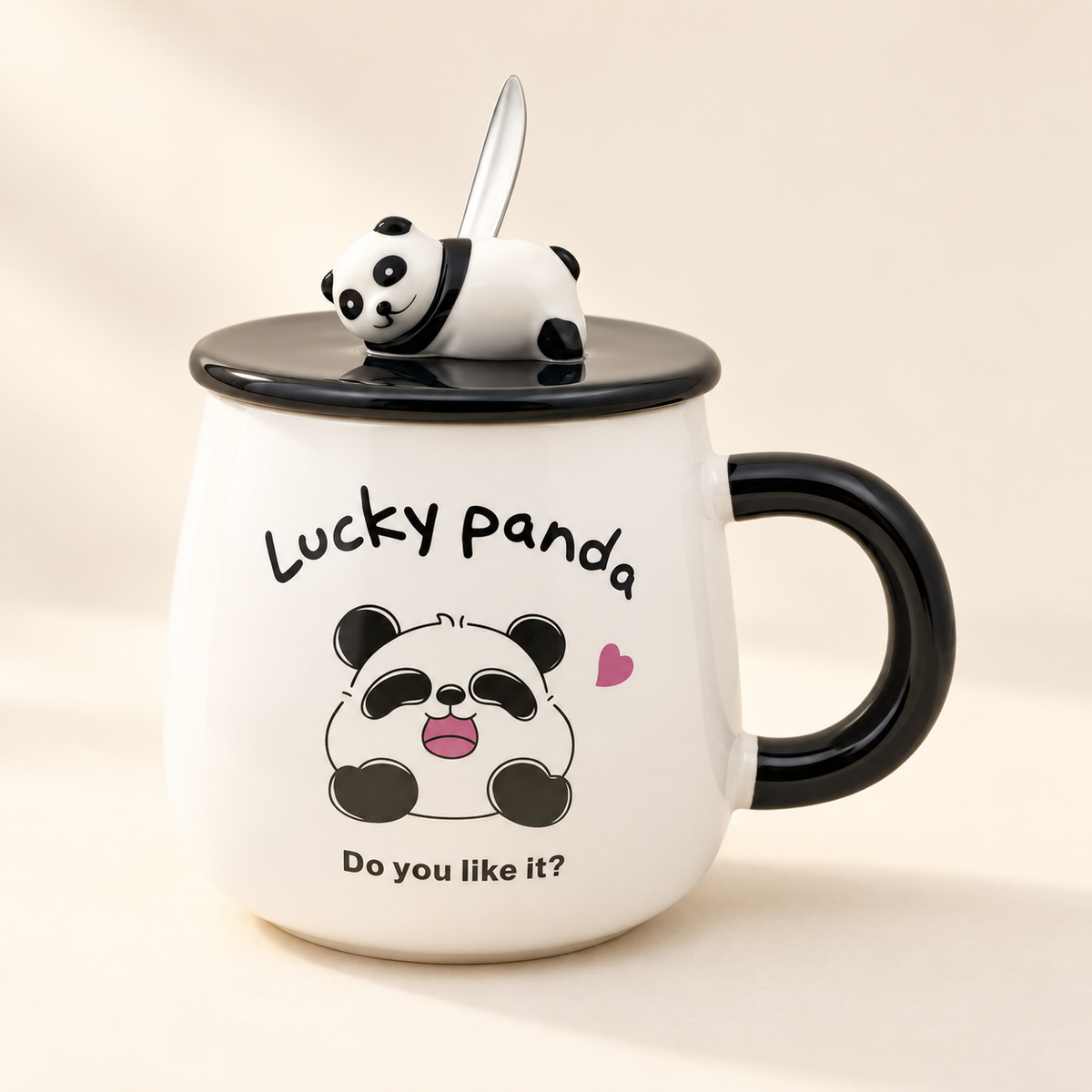 Fortune Panda ceramic mug with black handle, panda-topped lid and spoon on an ivory background. Panda design is supplied at random.