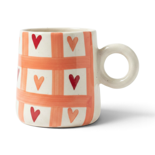 Ayethic handcrafted ceramic cup in ivory with a coral lattice pattern and small painted hearts and a round ring handle