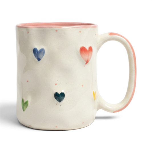 Ayethic handcrafted ceramic mug in cream with raised colourful heart motifs and a soft pink rim